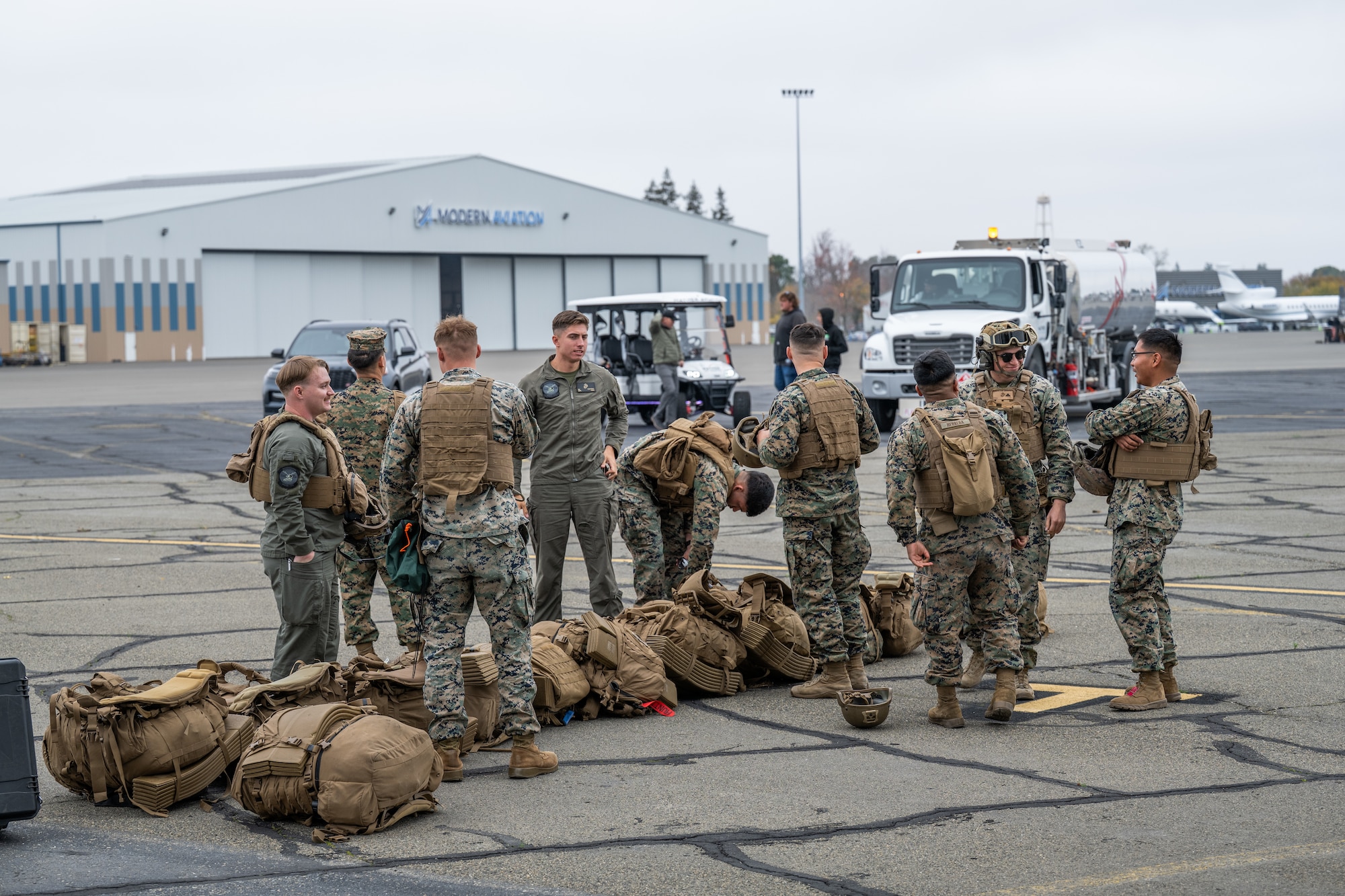 Airmen and Marines work together out on the flightline