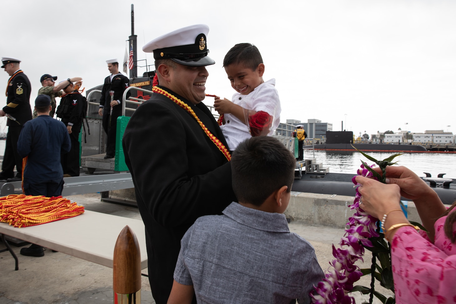 (Sept. 29, 2025) A Sailor assigned to Los Angeles-class fast-attack submarine USS Santa Fe (SSN 763) is welcomed home after returning to Naval Base Point Loma following a six-month deployment to the U.S. Indo-Pacific Command area of responsibility, Sept. 29, 2025. Santa Fe is assigned to Commander, Submarine Squadron 11, home to four Los Angeles-class fast-attack submarines, which are capable of supporting various missions, including anti-submarine warfare, anti-ship warfare, strike warfare and intelligence, surveillance and reconnaissance. (U.S. Navy photo by Mass Communication Specialist 2nd Class Rashan Jefferson)