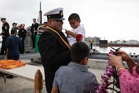 (Sept. 29, 2025) A Sailor assigned to Los Angeles-class fast-attack submarine USS Santa Fe (SSN 763) is welcomed home after returning to Naval Base Point Loma following a six-month deployment to the U.S. Indo-Pacific Command area of responsibility, Sept. 29, 2025. Santa Fe is assigned to Commander, Submarine Squadron 11, home to four Los Angeles-class fast-attack submarines, which are capable of supporting various missions, including anti-submarine warfare, anti-ship warfare, strike warfare and intelligence, surveillance and reconnaissance. (U.S. Navy photo by Mass Communication Specialist 2nd Class Rashan Jefferson)