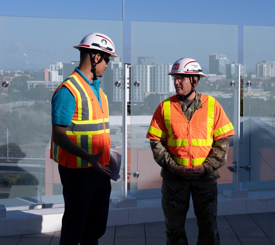 Roberto Paredes, resident engineer at the U.S. Army Corps of Engineers Los Angeles District's Department of Veterans Affairs San Diego Resident Office, left, talks with Brig. Gen. John Lloyd, USACE South Pacific Division commander, right, Dec. 3 at the Jennifer Moreno VA Medical Center campus in San Diego during his tour of the nearly complete San Diego VA Healthcare System Spinal Cord Injury/Community Living Center.