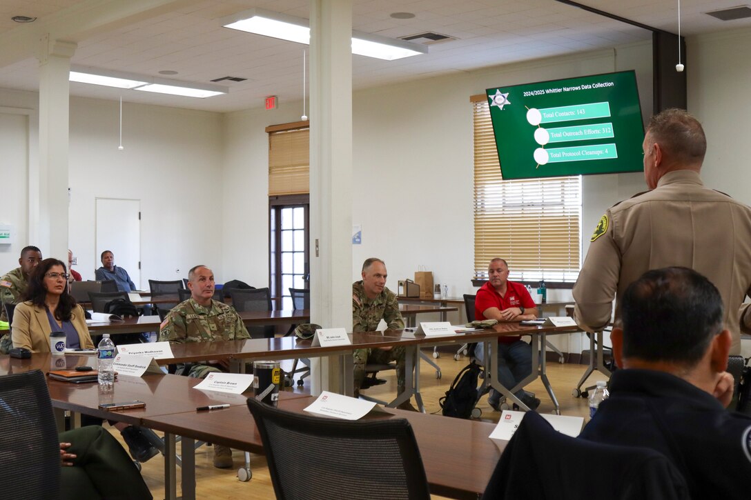 Brig. Gen. John Lloyd, U.S. Army Corps of Engineers South Pacific Division commander, left of center, and Col. Andrew Baker, USACE Los Angeles District commander, attend a briefing led by Cmdr. Geoffrey R. Deedrick, Los Angeles County Sheriff’s Department. USACE relies on local community partnerships when tending to its projects to ensure a safe working environment for employees, its contractors and nearby residents.