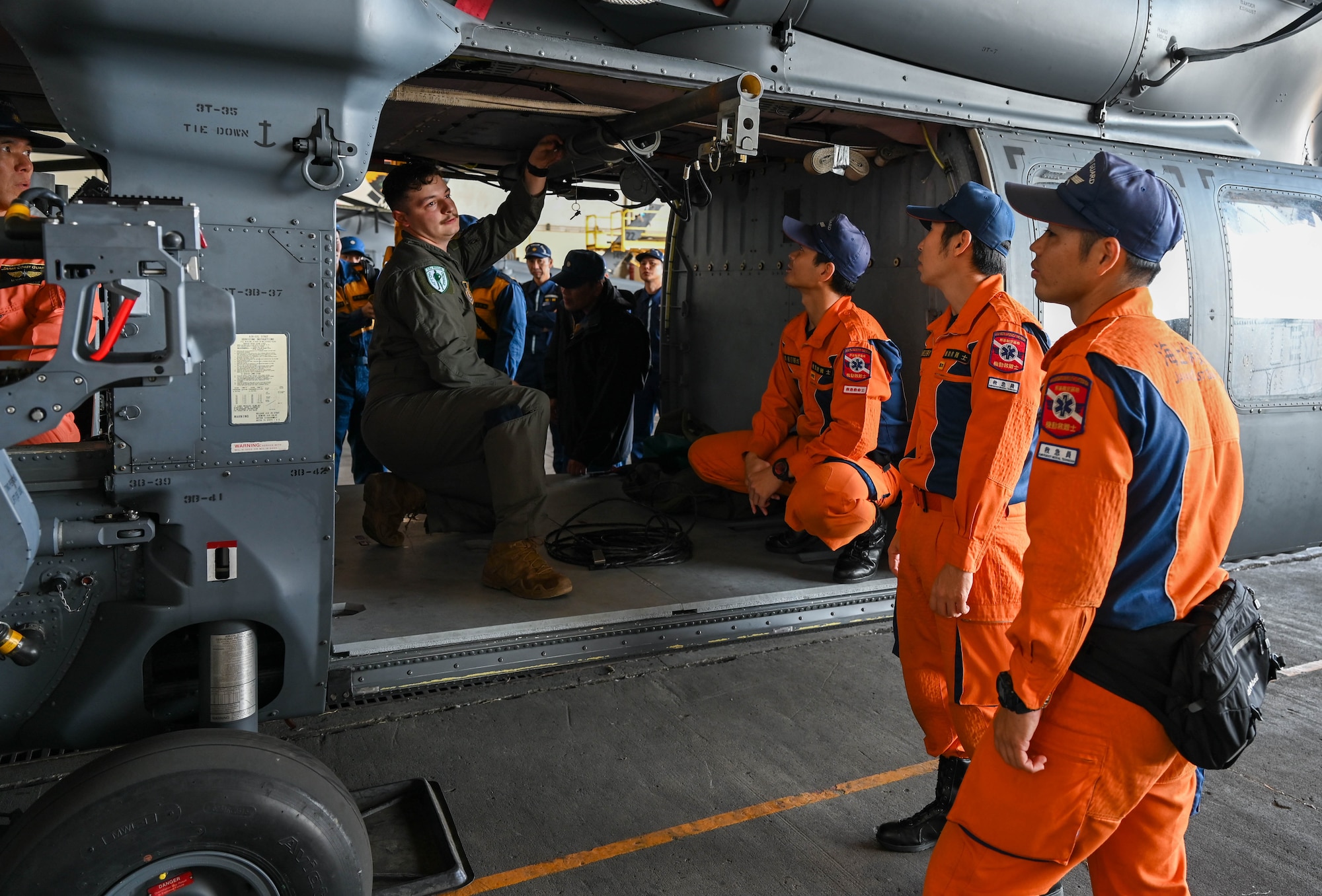 Service members showcase gear to local coast guard.
