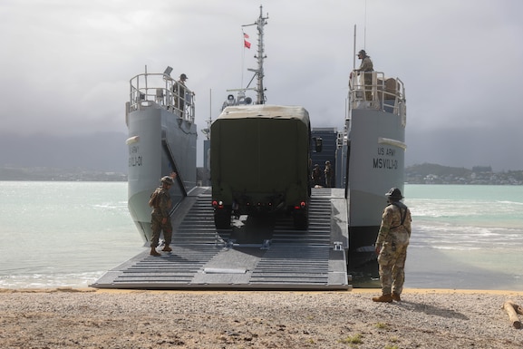 U.S. Marines and U.S. Army Soldiers guide vehicles off the U.S. Army Maneuver Support Vessel (Light) at Marine Corps Base Kaneohe Bay, Hawaii, Nov. 12, 2025.