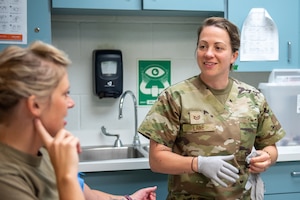 Tech. Sgt. Cristen E. Lane, an aerospace medicine technician for the 123rd Medical Group, speaks with a patient at the Kentucky Air National Guard Base in Louisville, Ky., Sept. 6, 2025. Lane has been named Air National Guard Aerospace Medicine Non-Commissioned Officer of the Year for 2024 by the National Guard Bureau. (U.S. Air National Guard photo by Angelee Barnett)