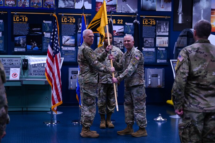 U.S. Space Force Col. Ryan Hiserote assumes command of System Delta 80 from Lt. Gen. Philip Garrant during a stand-up ceremony at Cape Canaveral Space Force Station, Fla., Dec. 12. SYD 80 will procure, integrate, and execute launch solutions, on-orbit servicing, and range systems. (U.S. Space Force photo/SrA Samuel Becker)