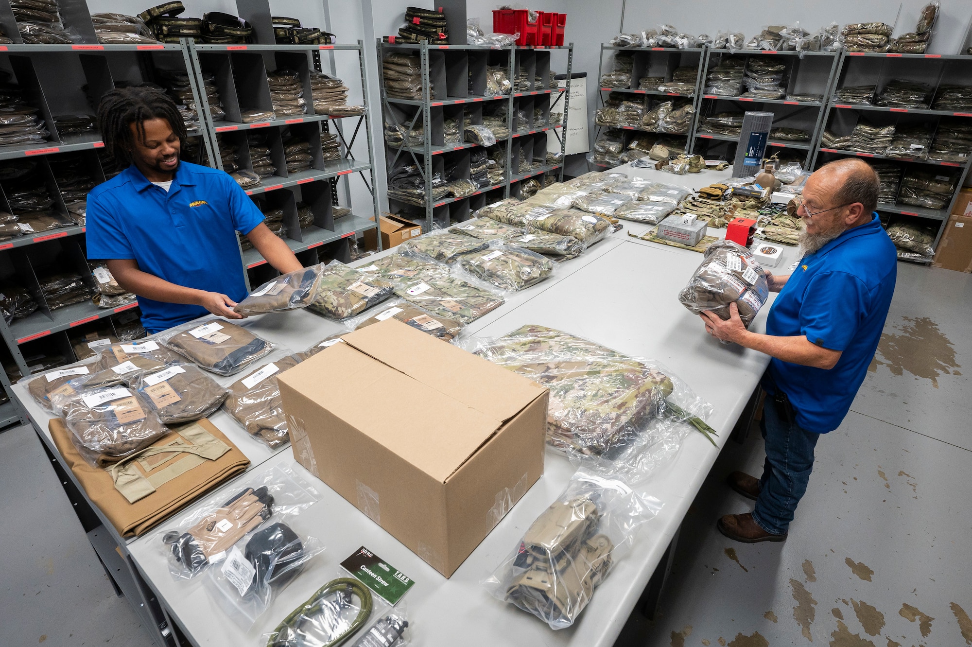 Two workers pack boxes.
