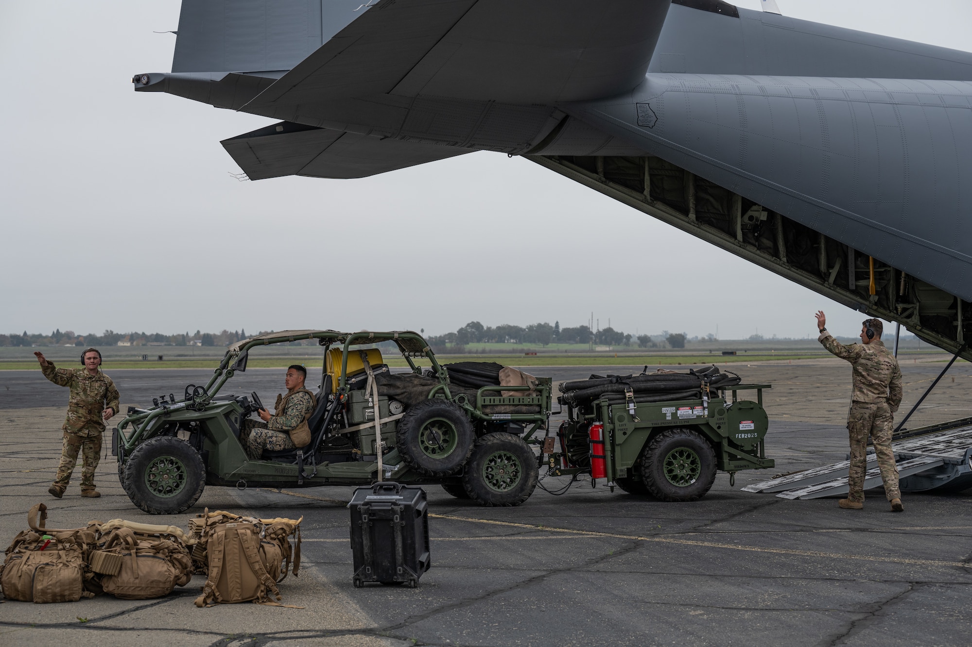 Airmen and Marines work together out on the flightline
