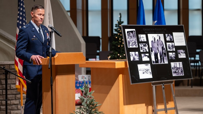 U.S. Air Force Col. Ryan Ley, 51st Fighter Wing commander, delivers closing remarks during the Operation Kiddy Car 75th anniversary ceremony at Osan Air Base, Republic of Korea, Dec. 17, 2025. Operation Kiddy Car is a historic humanitarian mission that occurred on Dec. 20, 1950, when U.S. Air Force Lt. Col. Russell Blaisdell, a chaplain, and Staff Sgt. Merle Strang worked together to rescue more than 1,000 Korean orphans and their caretakers from war-torn Seoul. The actions of Blaisdell and Strang exemplified courage, compassion, and decisive leadership in the face of crisis, showcasing the core mission of the Chaplain Corps by safeguarding innocent lives amid chaos and uncertainty. (U.S. Air Force photo by Staff Sgt. Sarah Williams)
