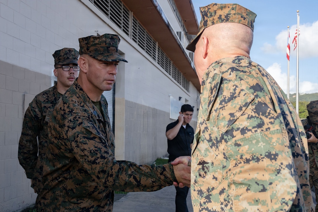 The senior enlisted leader of Marine Fighter Attack Squadron (VMFA) 225, U.S. Marine Corps Forces, South, shakes hands with The 39th Commandant of the Marine Corps, Gen. Eric M. Smith, at Jose Aponte de la Torre Airport in Ceiba, Puerto Rico, Dec. 16, 2025. U.S. military forces are deployed to the Caribbean in support of the U.S. Southern Command mission, Department of War-directed operations, and the president’s priorities to disrupt illicit drug trafficking and protect the homeland. (U.S. Marine Corps photo)