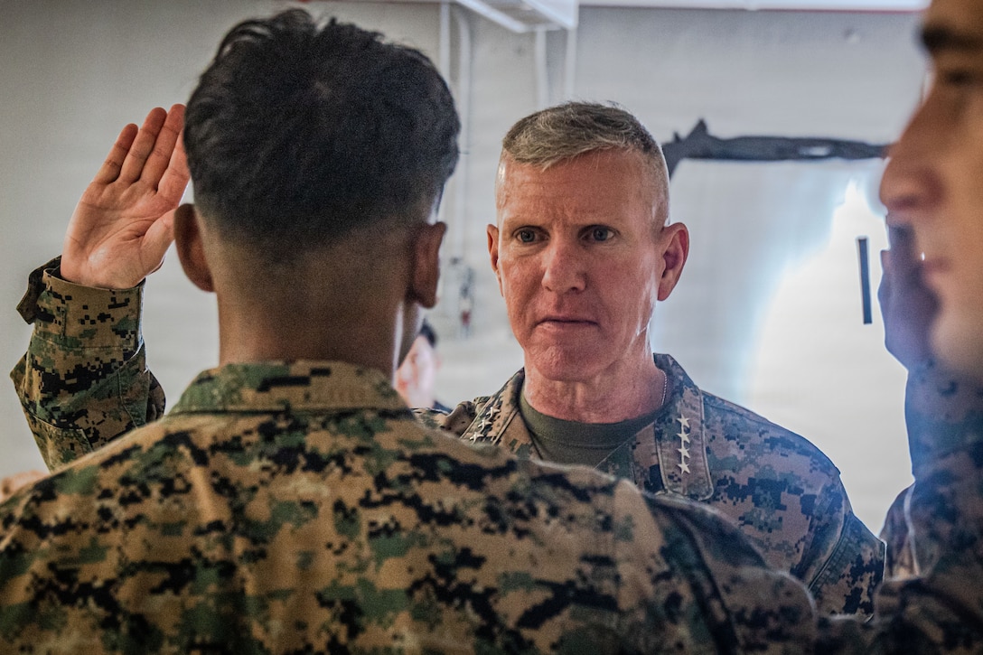 The 39th Commandant of the Marine Corps, Gen. Eric M. Smith, re-administers the oath of enlistment to a U.S. Marine with Marine Fighter Attack Squadron (VMFA) 225, U.S. Marine Corps Forces, South, before meritoriously promoting him to the rank of sergeant at Jose Aponte de la Torre Airport in Ceiba, Puerto Rico, Dec. 16, 2025. U.S. military forces are deployed to the Caribbean in support of the U.S. Southern Command mission, Department of War-directed operations, and the president’s priorities to disrupt illicit drug trafficking and protect the homeland. (U.S. Marine Corps photo)