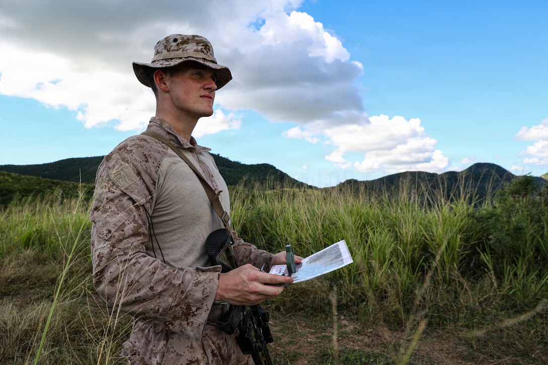 A U.S. Marine with Kilo Company, Battalion Landing Team 3/6, 22nd Marine Expeditionary Unit (Special Operations Capable), uses a map and compass during land navigation training in Camp Santiago, Puerto Rico, Dec. 3, 2025. U.S. military forces are deployed to the U.S. Southern Command area of responsibility in support of Operation SOUTHERN SPEAR, Department of War-directed operations, and the president's priorities to disrupt illicit drug trafficking and protect the homeland. (U.S. Marine Corps photo)