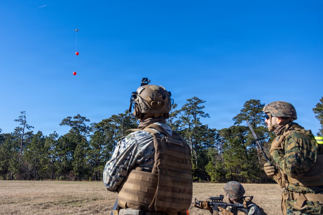 U.S. Marines with 2nd Low Altitude Air Defense Battalion, Marine Air Control Group 28, 2nd Marine Aircraft Wing, use the SMARTSHOOTER system to open fire on moving unmanned aerial systems (UAS) at Marine Corps Base Camp Lejeune, North Carolina, Dec. 16, 2025. The SMARTSHOOTER system was developed with computer vision and machine learning technology and can be mounted to small arms weapons to target UAS. This system increases 2nd LAAD's counter-UAS capabilities. (U.S. Marine Corps photo by Lance Cpl. Gavin K. Kulczewski)