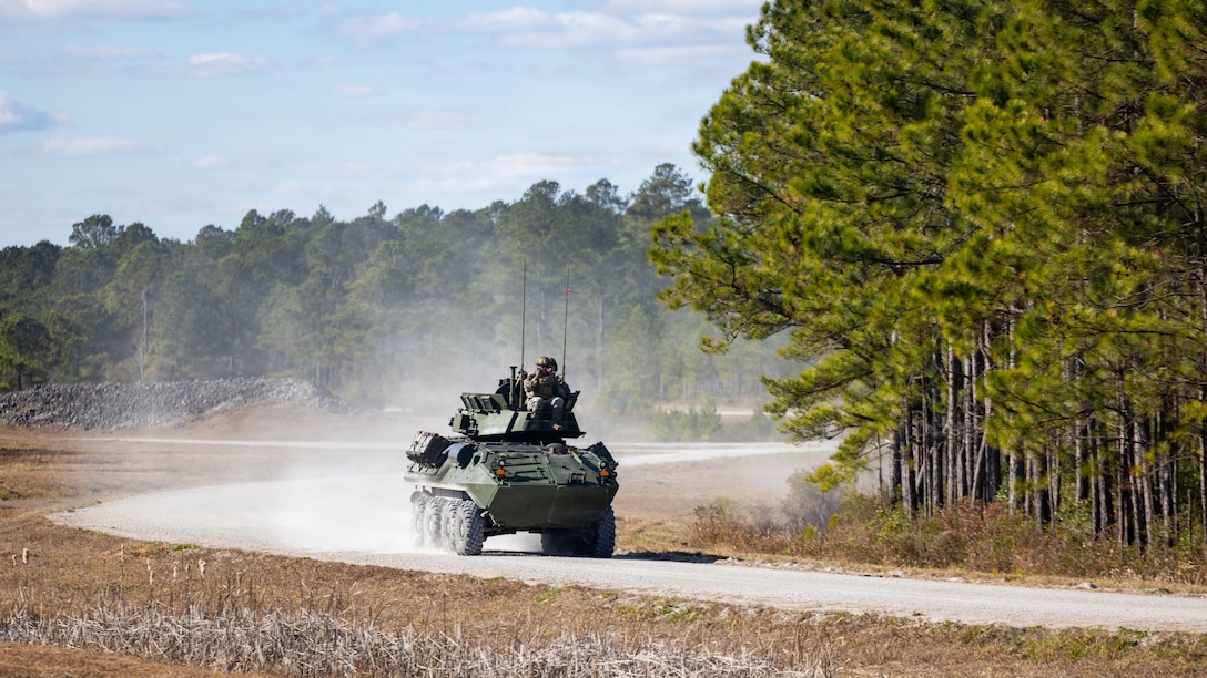 U.S. Marines with 2nd Light Armored Reconnaissance Battalion, 2nd Marine Division displace from the range during a Tube-launched, Optically-tracked, Wire-guided missile range on Marine Corps Base Camp Lejeune, North Carolina, Dec. 11, 2025. The range integrates the long range, standoff capabilities of the TOW missile with the battlespace awareness advantages of LAR scout teams and the direct fire capabilities of the Light Armored Vehicle 25’s 30mm Bushmaster chain gun. (U.S. Marine Corps photo by Lance Cpl. Brian Bolin Jr.)
