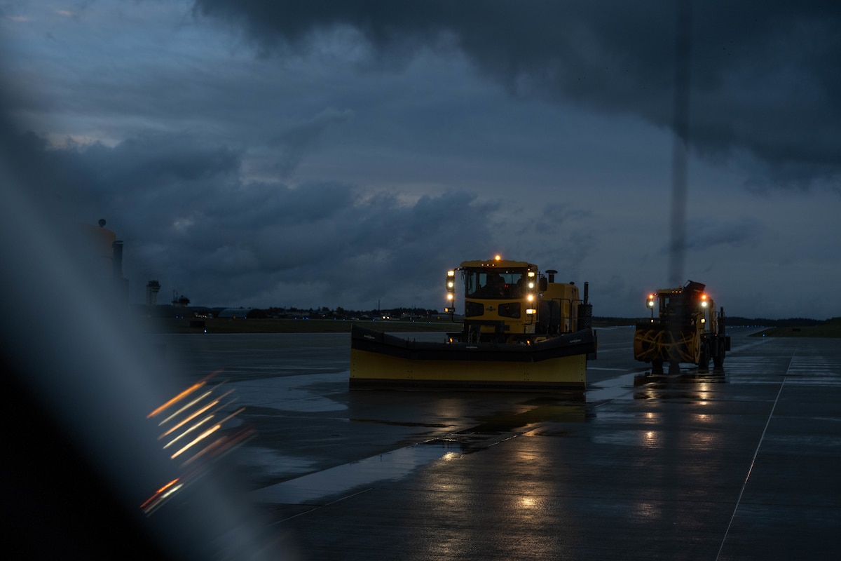 Snow removal vehicle drives on a road.