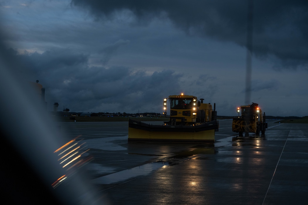 Snow removal vehicle drives on a road.