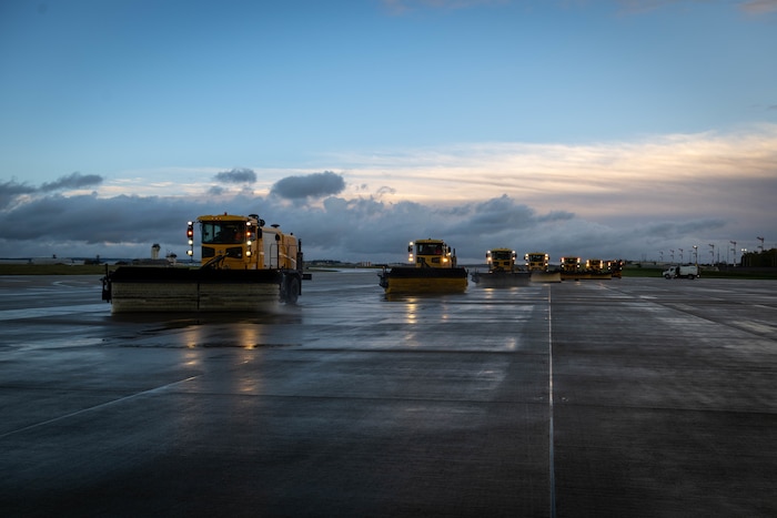 Snow removal vehicle drives on a road.