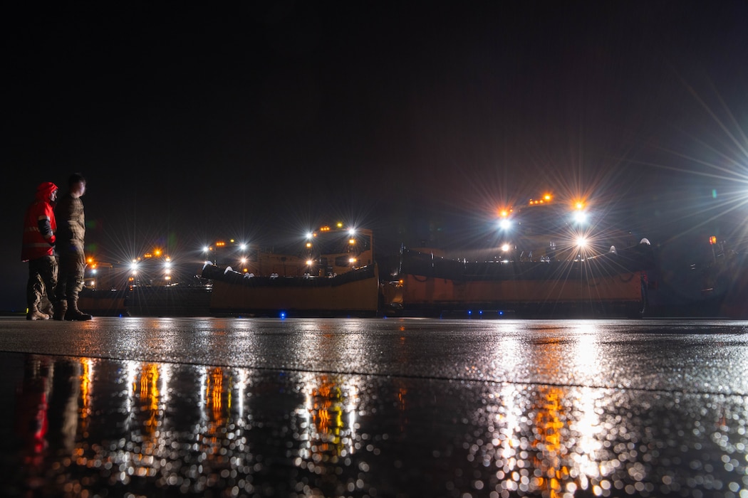 Snow removal vehicle drives on a road.