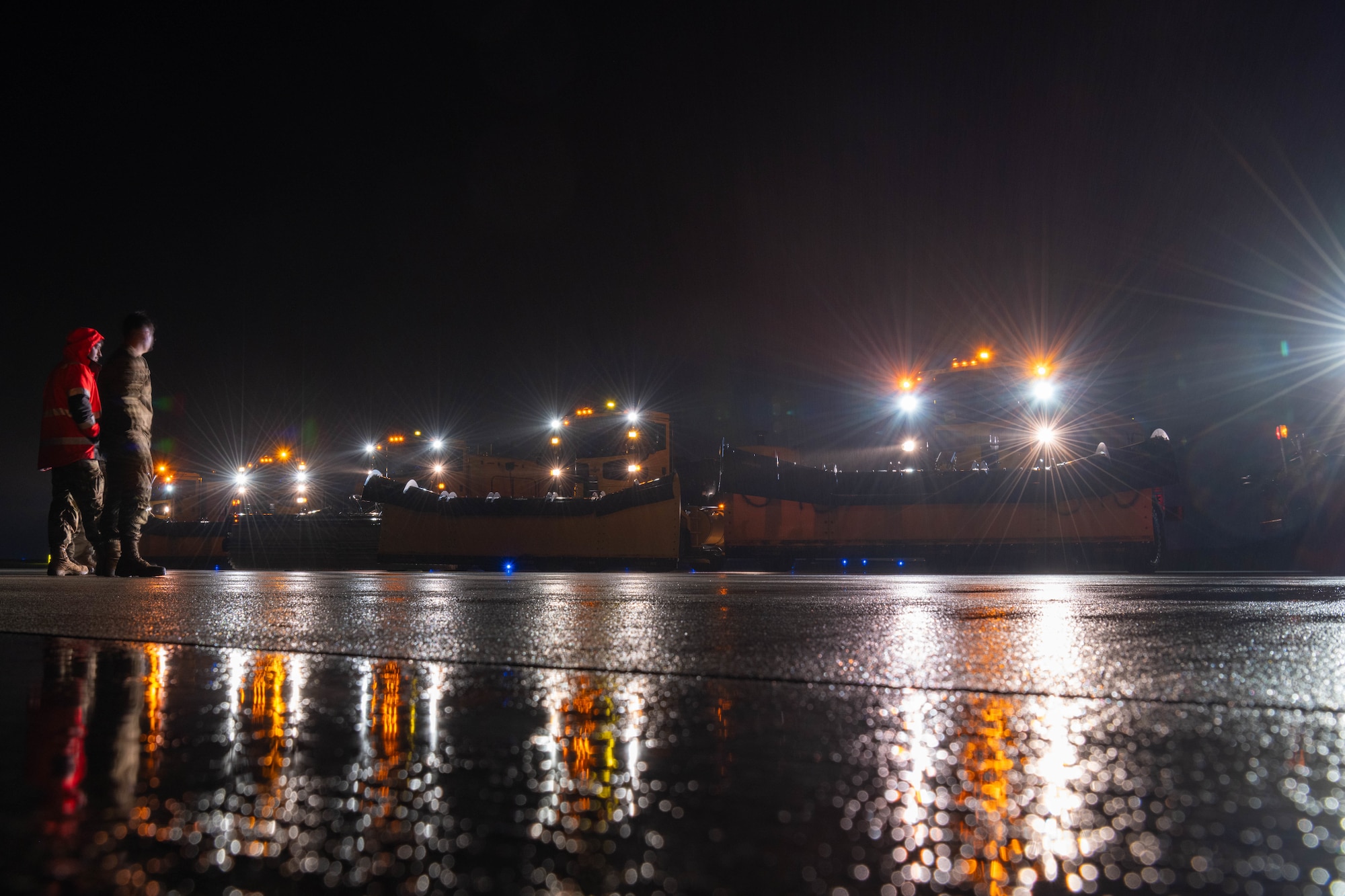 Snow removal vehicle drives on a road.