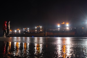 Snow removal vehicle drives on a road.