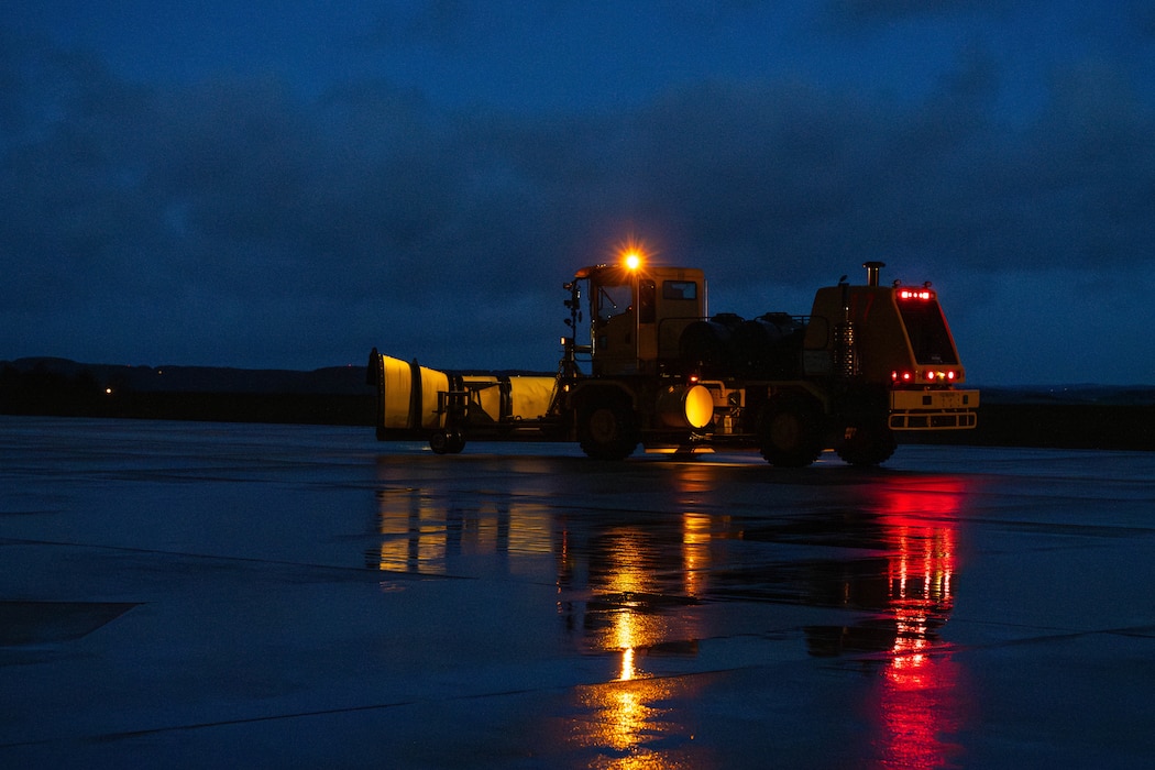 Snow removal vehicle drives on a road.