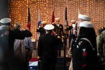 U.S. Navy Rear Adm. Kevin Kennedy, Deputy Chief of Naval Personnel Command and Commander Navy Personnel Command, salutes Naval Consolidated Brigade Charleston leadership while walking towards the stage during the NCBC change of command ceremony.