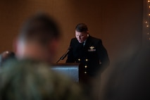 U.S. Navy Lt. Cmdr. Joseph Gilliam, USN Chaplain Corps chaplain, presents the invocation during the Naval Consolidated Brig Charleston change of command ceremony.