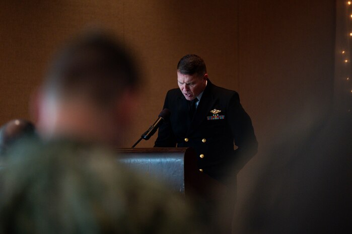 U.S. Navy Lt. Cmdr. Joseph Gilliam, USN Chaplain Corps chaplain, presents the invocation during the Naval Consolidated Brig Charleston change of command ceremony.