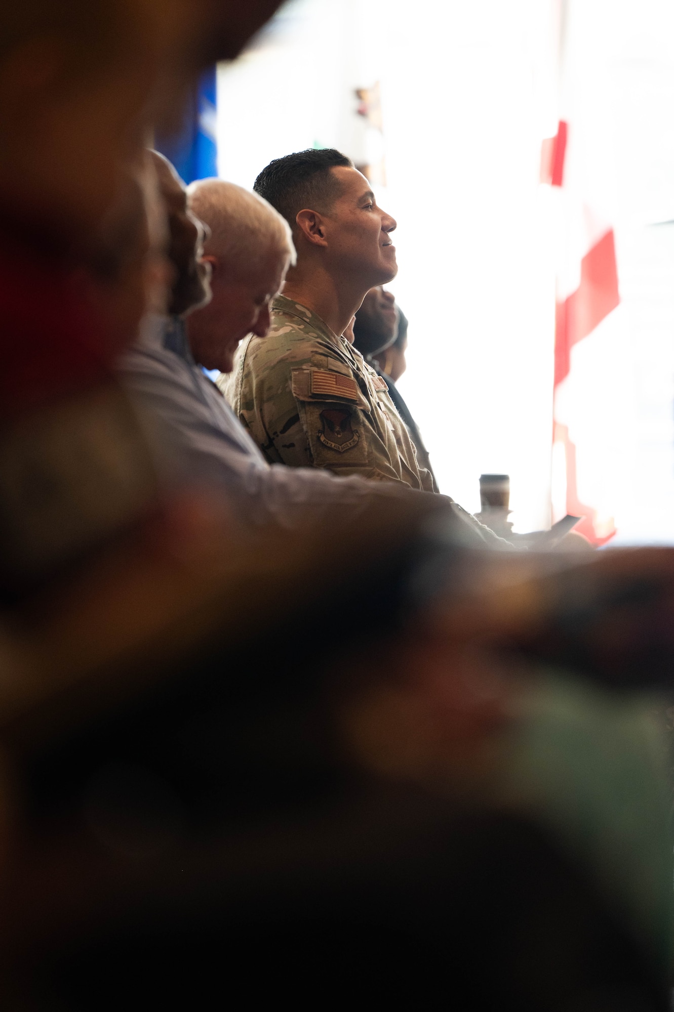 U.S. Air Force Col. Jason Parker, Joint Base Charleston and 628th Air Base Wing commander, listens to U.S. Navy Cmdr. Joseph Brisco, Naval Consolidated Brig Charleston outgoing executive commander, as he thanks his support system during the NCBC change of command ceremony.