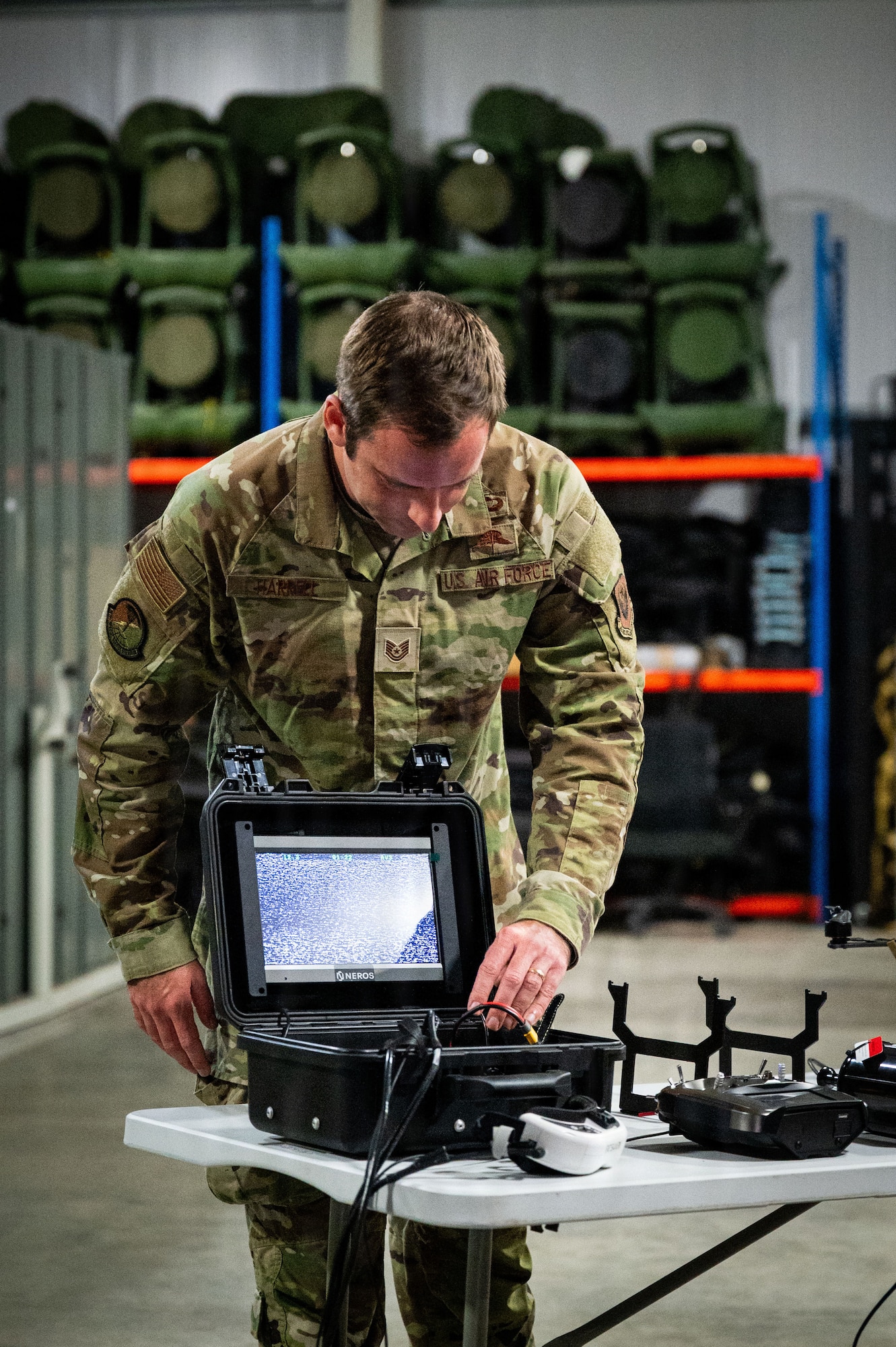 U.S. Air Force Tech. Sgt. Travis Harrell, 321st Special Tactics Squadron special reconnaissance, turns on a display during a professional staff members of the Senate Armed Services Committee visit at RAF Mildenhall, England, Dec. 16, 2025.