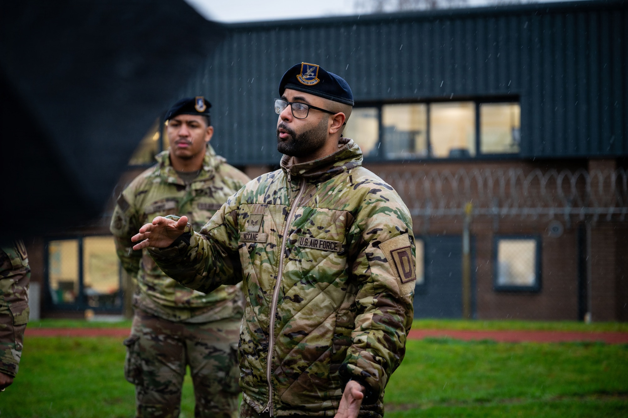 U.S. Air Force Senior Airman Chad McCane, 100th Security Forces Squadron program manager, briefs professional staff members of the SASC during their visit to RAF Mildenhall, England, Dec. 16, 2025.