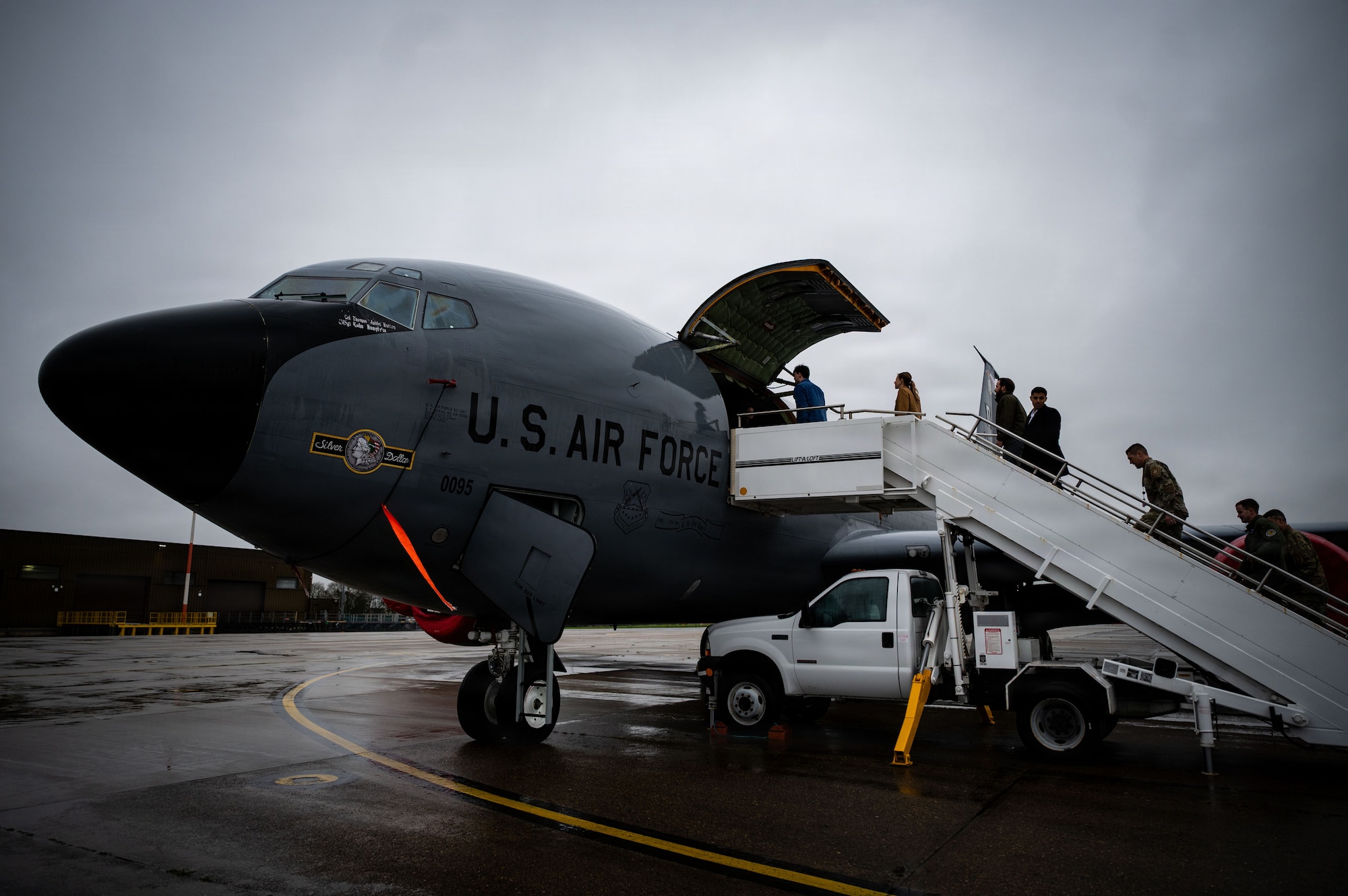 Professional staff members of the Senate Armed Services Committee enter a KC-135 Stratotanker assigned to the 100th Air Refueling Wing during a visit at RAF Mildenhall, England, Dec. 16, 2025.