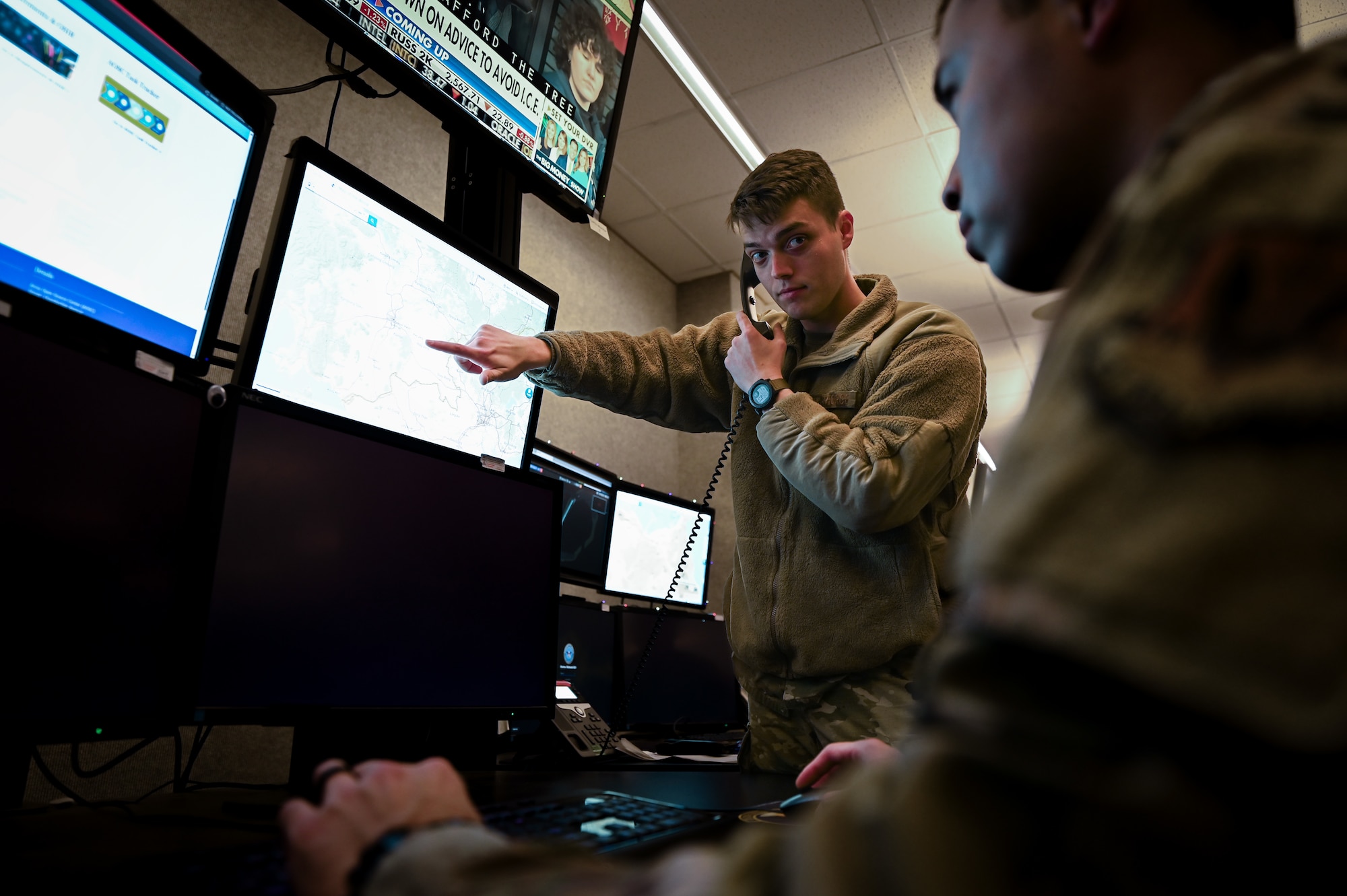 Airmen working together on computers