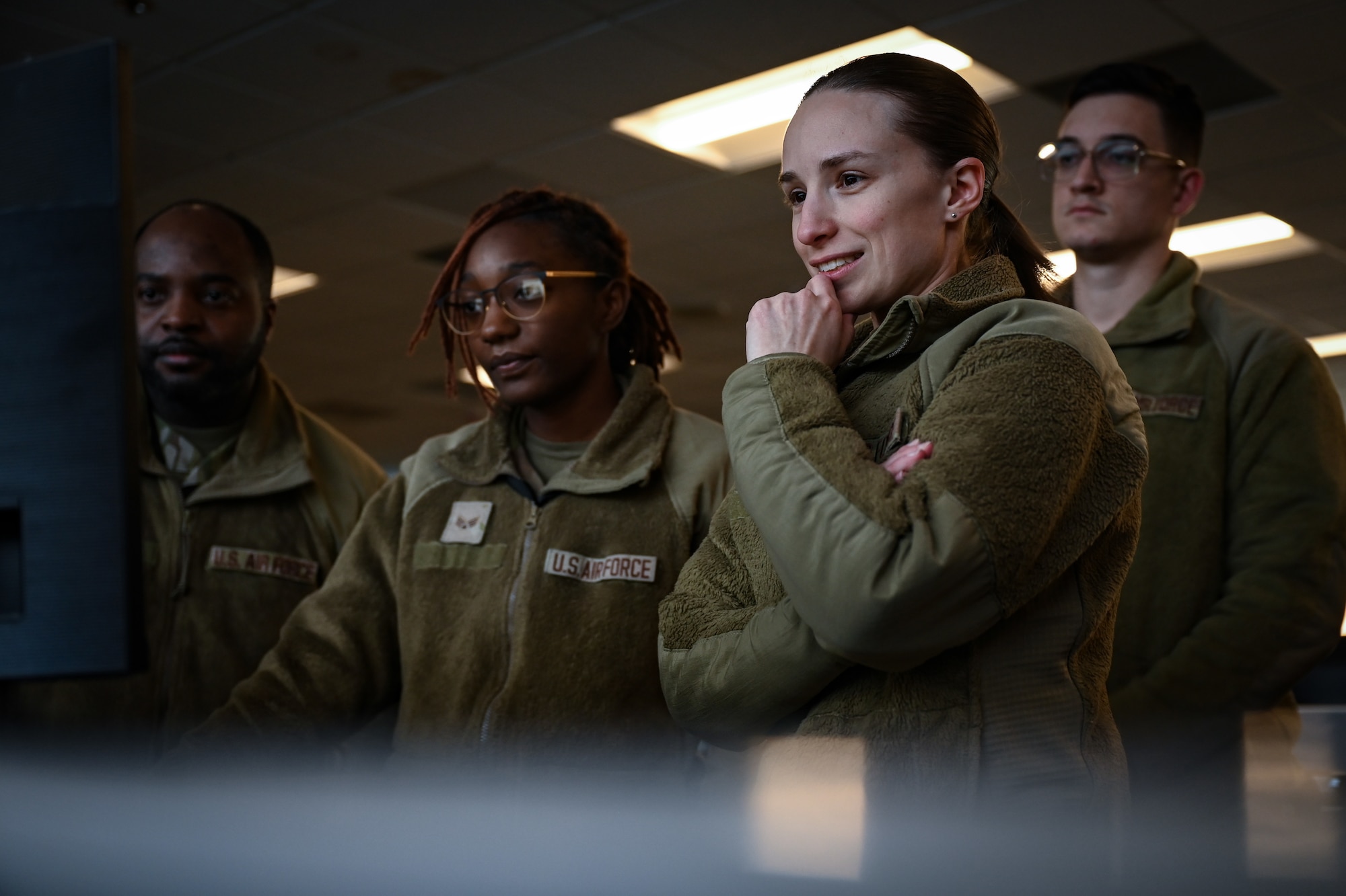 Airmen looking at a computer