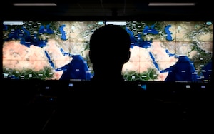 Photo of person in front of large screen