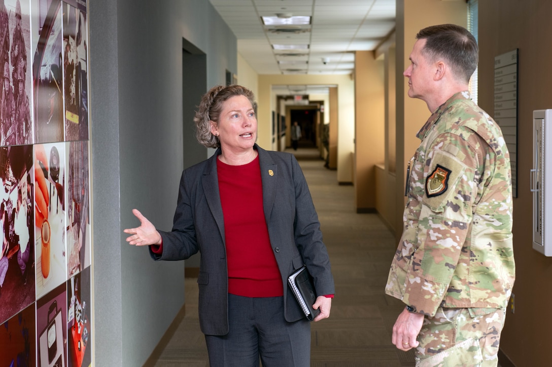 Brig. Gen. Amy Bumgarner, commander of the Air Force Office of Special Investigations, briefs Lt. Gen. David B. Lyons, Inspector General of the Department of the Air Force, during a tour of AFOSI headquarters at the Russell-Knox Building in Quantico, Virginia, Dec. 15, 2025.