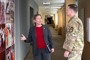 Brig. Gen. Amy Bumgarner, commander of the Air Force Office of Special Investigations, briefs Lt. Gen. David B. Lyons, Inspector General of the Department of the Air Force, during a tour of AFOSI headquarters at the Russell-Knox Building in Quantico, Virginia, Dec. 15, 2025.
