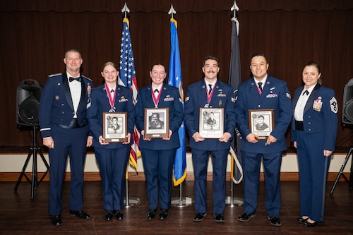 A group photo of men and women in formal Air Force dress uniforms