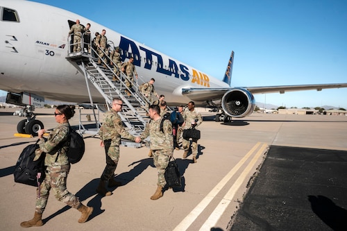 U.S. Air Force Airmen return from a deployment with the 11th Air Task Force at Davis-Monthan Air Force Base, Arizona, Dec. 17, 2025. Airmen were welcomed home by members of their command team while getting off the aircraft. (U.S. Air Force photo by Airman 1st Class Samantha Melecio)