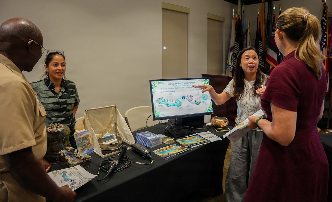 Capt. Gregory deWindt, chief of staff, Navy Closure Task Force-Red Hill (NCTF-RH), and Meagan Ostrem, community engagement director, NCTF-RH, speak with representatives from the University of Hawaii about the university’s independent Halawa Stream ecological monitoring studies during the NCTF-RH open house held at the Oahu Veterans Center in Honolulu, Dec. 11, 2025. NCTF-RH hosted the quarterly open house for members of the community to learn about current and future efforts in support of the Red Hill Bulk Fuel Storage Facility (RHBFSF) decommissioning and the Navy’s ongoing environmental efforts. NCTF-RH was established by the Department of the Navy to safely decommission the RHBFSF and emphasize the Navy's commitment to the community and the environment. NCTF-RH continues to engage with the people of Hawaii, regulatory agencies, and other stakeholders as it safely and deliberately decommissions the facility. (U.S. Navy photo by Mass Communication Specialist 1st Class Glenn Slaughter)