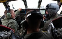 U.S. Navy Adm. Rich Correll (left), is shown the interior of a B-52H Stratofortress' cockpit by two 69th Bomb Squadron aircrew members.