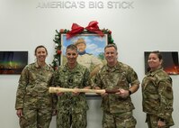 U.S. Strategic Command leadership and 91st Missile Wing leadership pose for a photo while holding a Bully Stick.