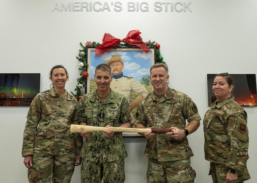 U.S. Strategic Command leadership and 91st Missile Wing leadership pose for a photo while holding a Bully Stick.