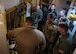 U.S. Navy Adm. Rich Correll receives a briefing from Airmen while inside of a training missile launch facility.