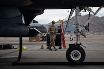 a person walks past a jet