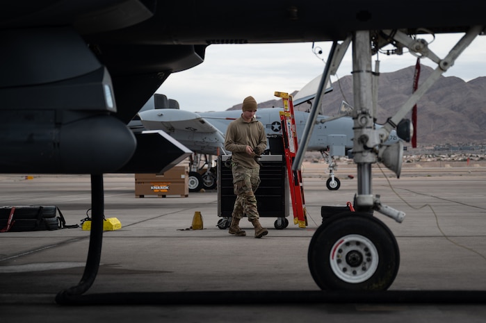 a person walks past a jet