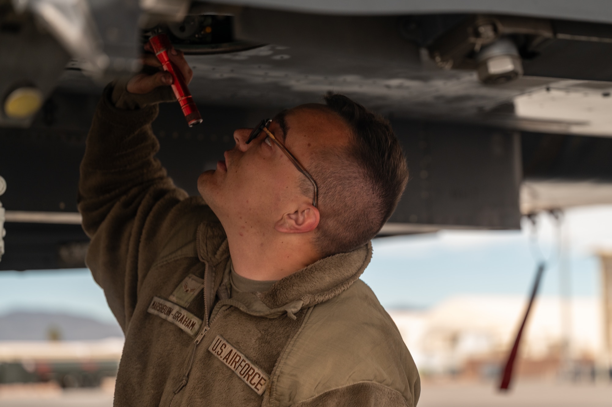 a person inspects a jet
