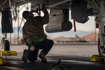 a person inspects a jet