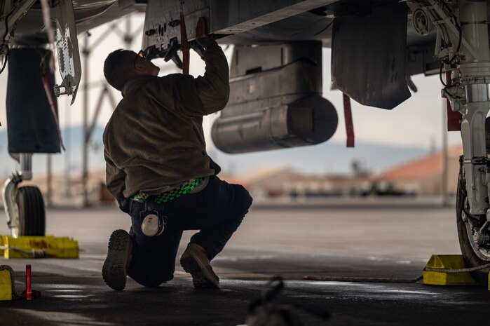 a person inspects a jet