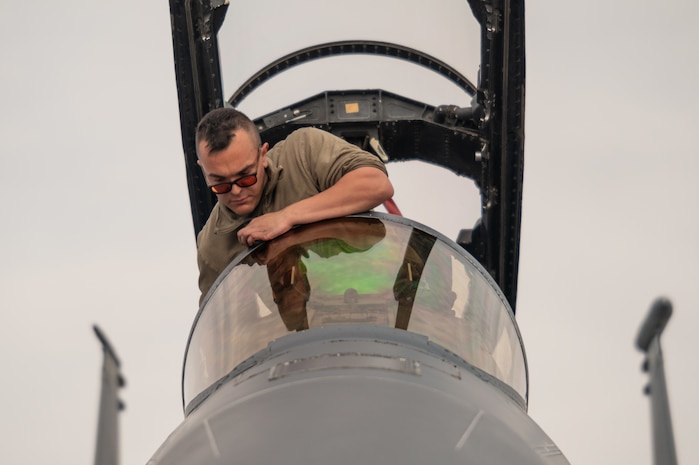 a person looks at a jet window