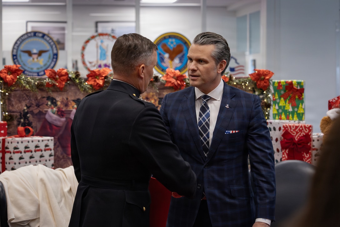 The Secretary of War, Pete Hegseth, right, talks to U.S. Marine Corps Lt. Gen. Leonard F. Anderson IV, commander of Marine Forces Reserve and Marine Forces South, during a Toys for Tots charity drive and members of the U.S. Naval Academy at the Pentagon, Washington, D.C., Dec. 9, 2025. Since 1947, the Marine Corps Reserve has spearheaded the Toys for Tots program nationwide to collect toys for less fortunate children during the holiday season. Presently, the program distributes 7 to 18 million toys to children annually. (U.S. Marine Corps photo by Lance Cpl. Van Hoang)